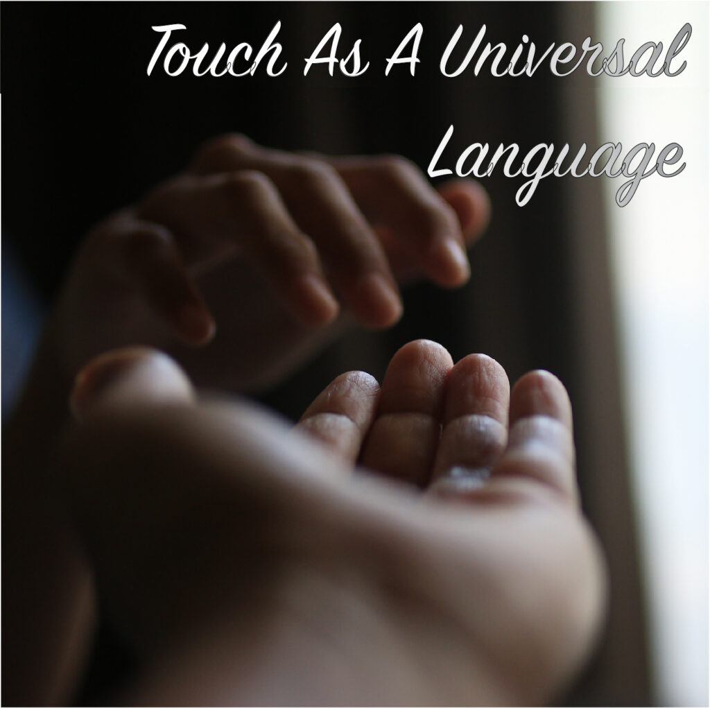 Touch As A Universal Language - Image of hand reaching out to touch another